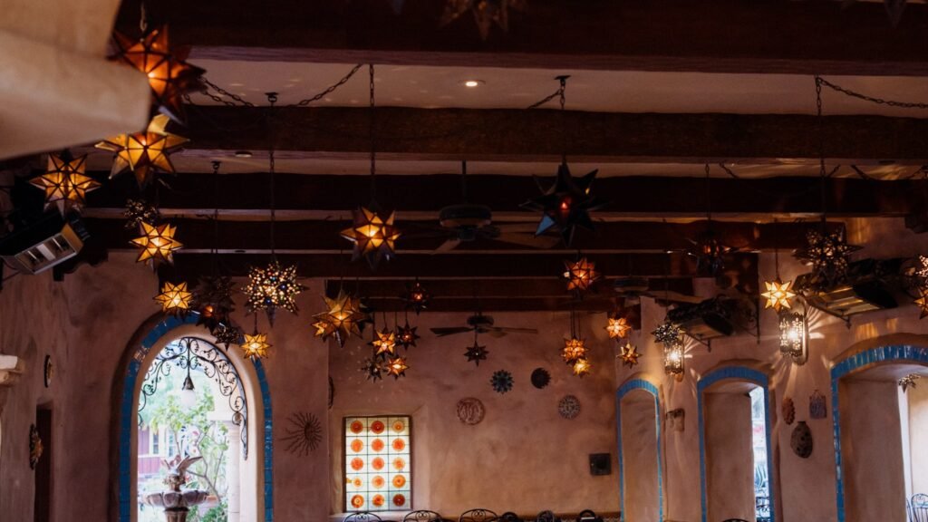 a church with a stained glass window and star decorations hanging from the ceiling