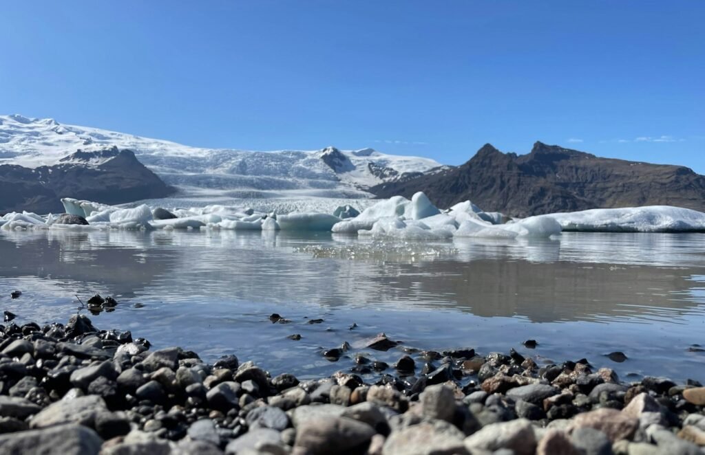 a group of icebergs floating on top of a body of water