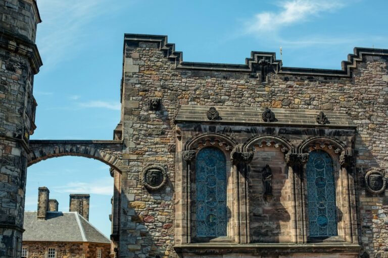 a large stone building with a clock on it's side