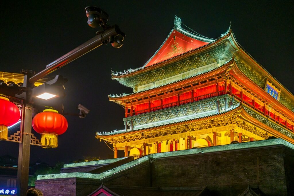 a chinese building lit up at night with red lanterns