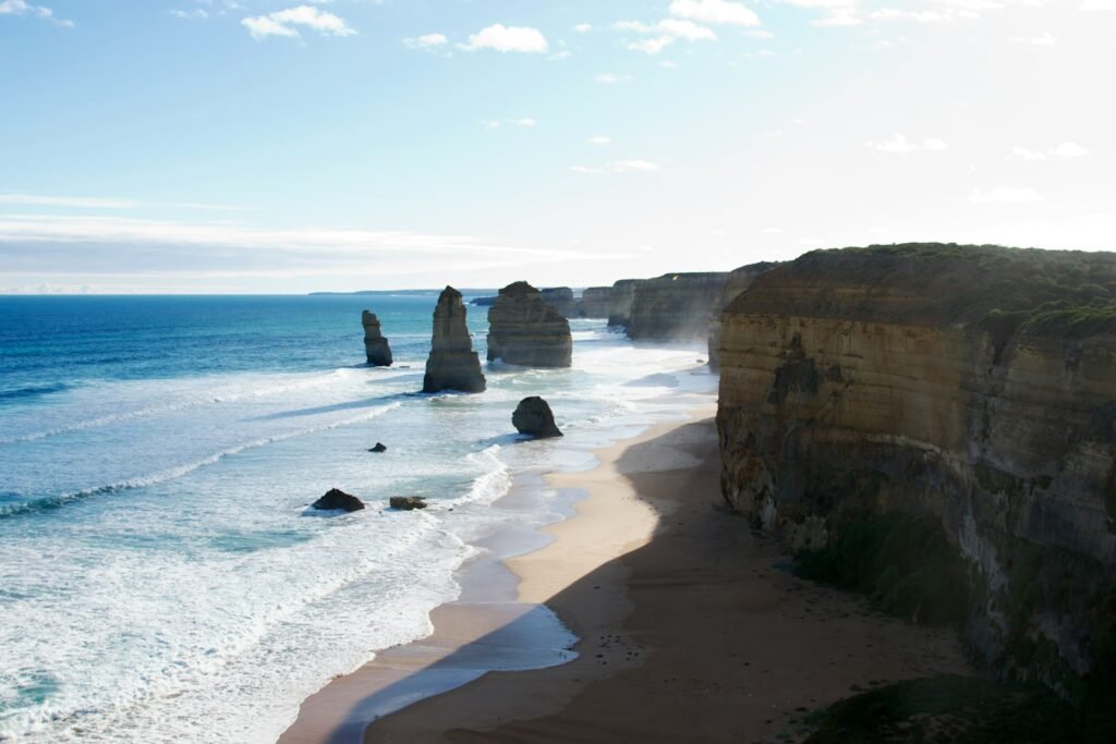 A view of a beach with a rock formation in the water