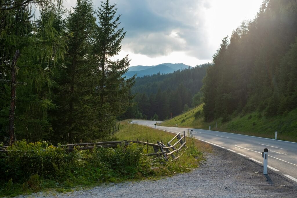 a road with a wooden fence on the side of it