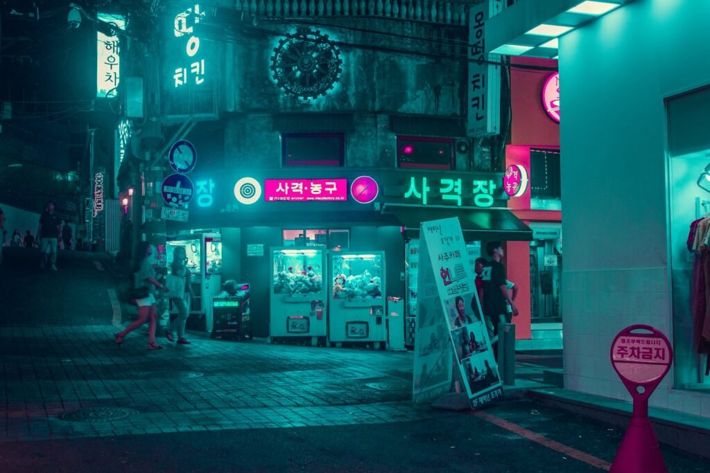 group of people walking on the street near buildings at night time