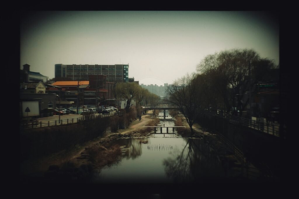 A river running through a city next to a tall building