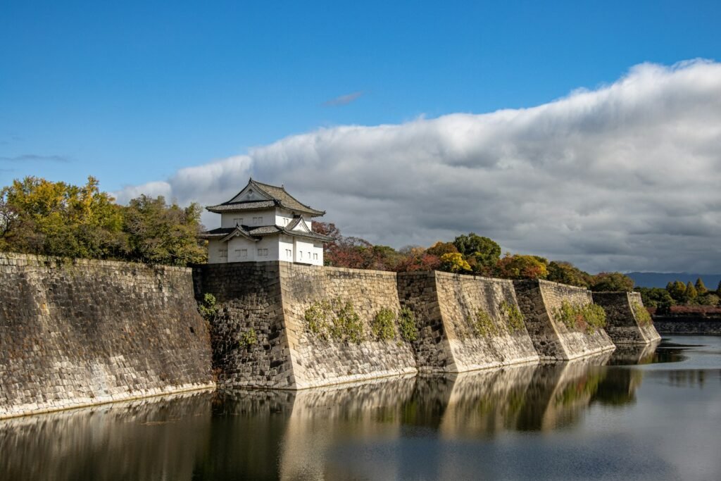 a large body of water next to a stone wall