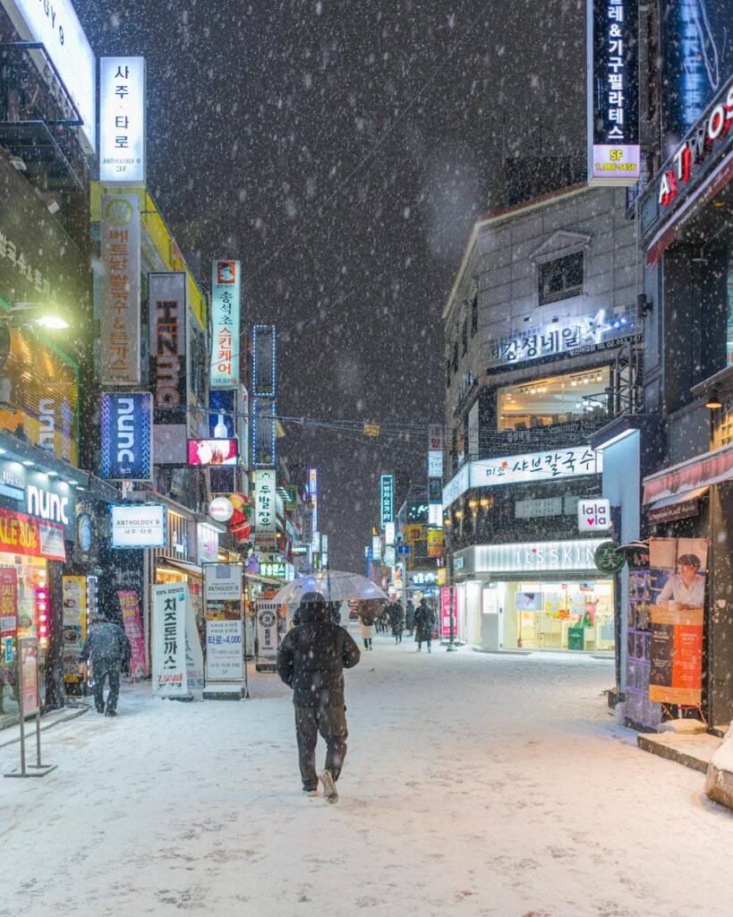 a man walking down a snow covered street