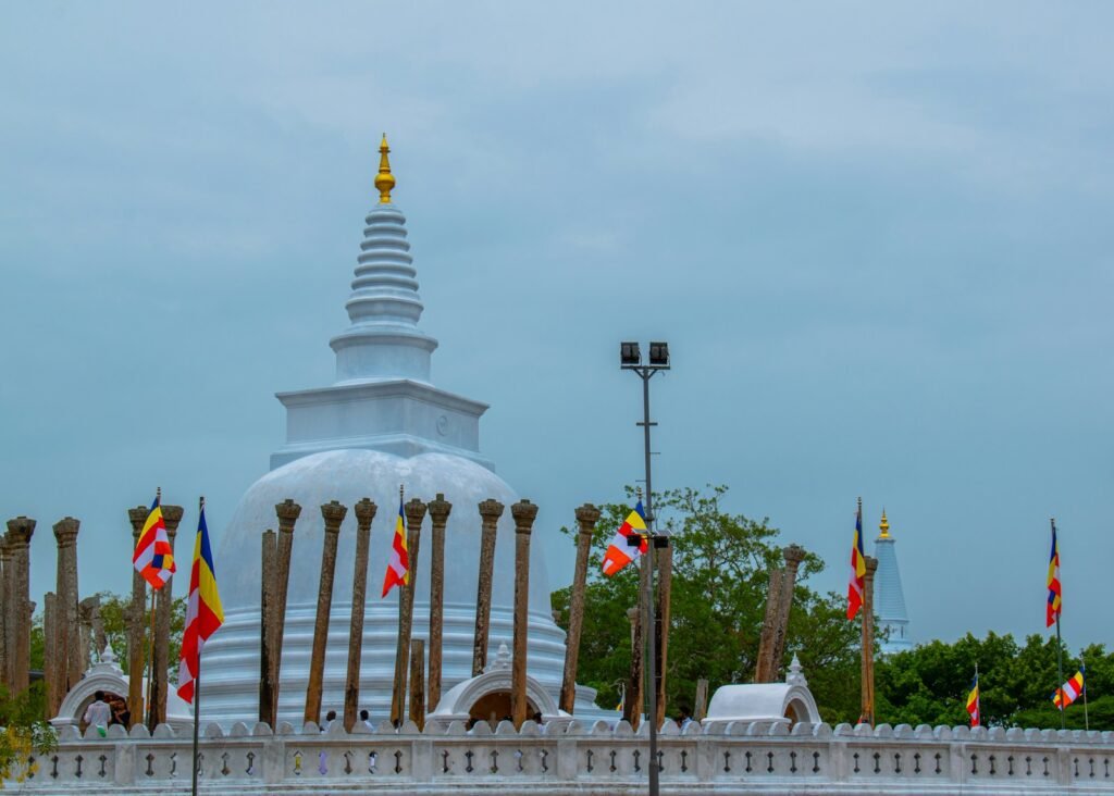 a large white building with many flags around it